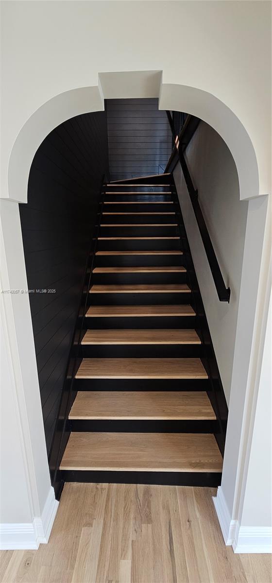 stairway featuring wood finished floors