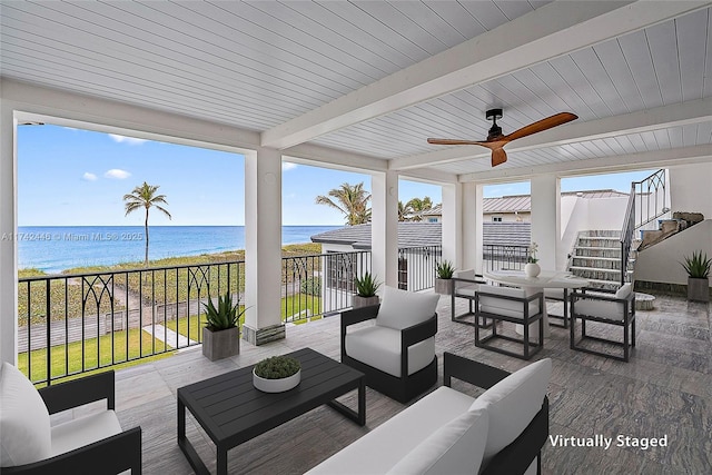 sunroom featuring a water view, ceiling fan, beam ceiling, and wooden ceiling