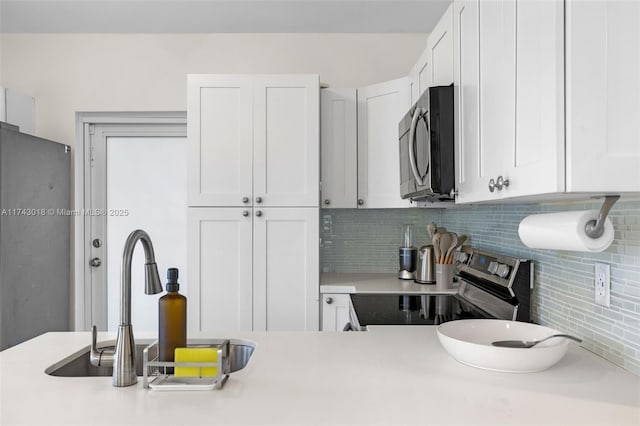 kitchen with white cabinetry, sink, and stainless steel appliances