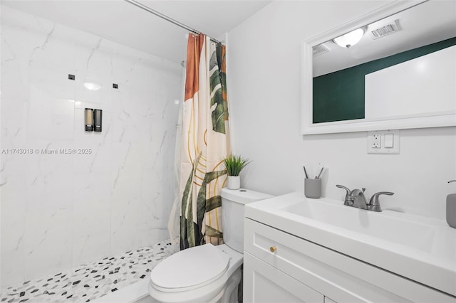 bathroom featuring vanity, toilet, and curtained shower