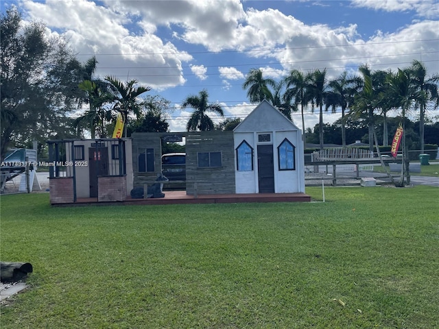 surrounding community with a yard and a playground