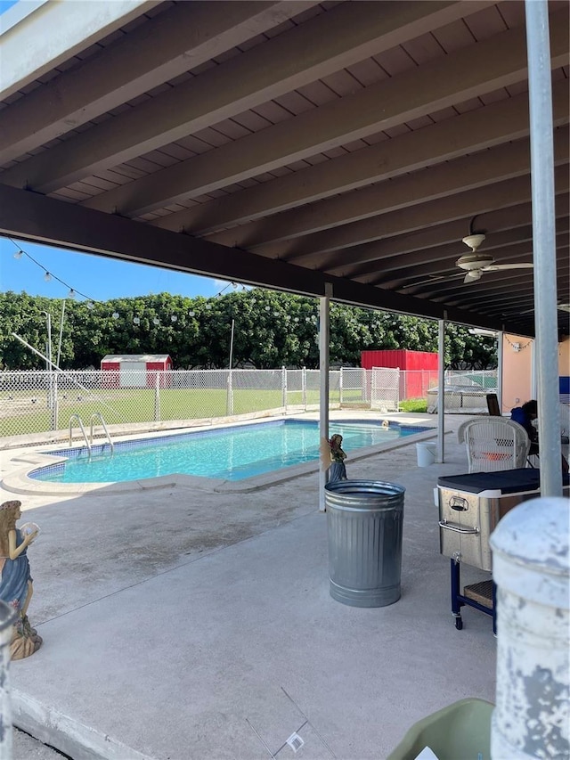 view of pool with a patio and ceiling fan