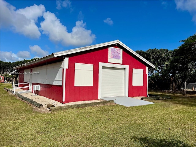 view of outbuilding featuring a yard and a garage