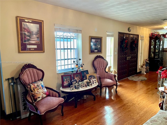 sitting room with hardwood / wood-style flooring