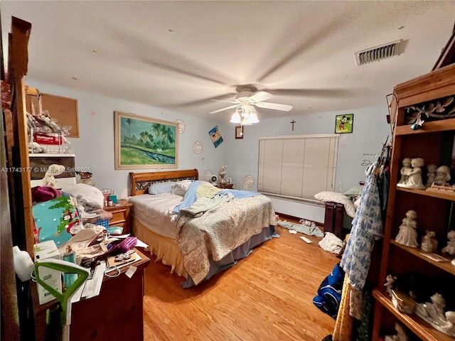 bedroom with ceiling fan and wood-type flooring