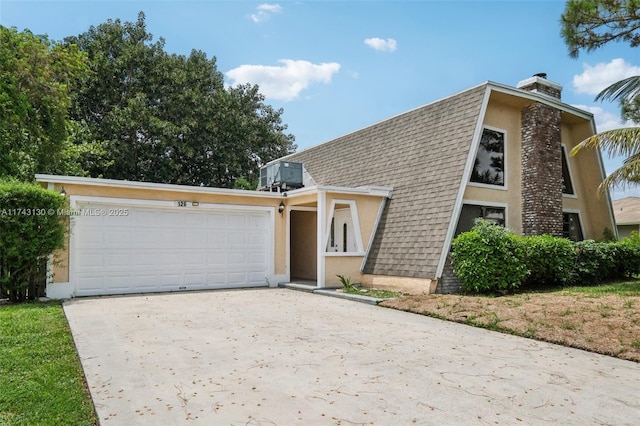 view of front of home featuring a garage and central AC