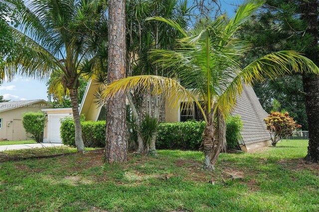 view of side of home with a garage and a yard