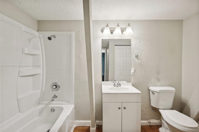 full bathroom featuring vanity, a textured ceiling, shower / washtub combination, and toilet