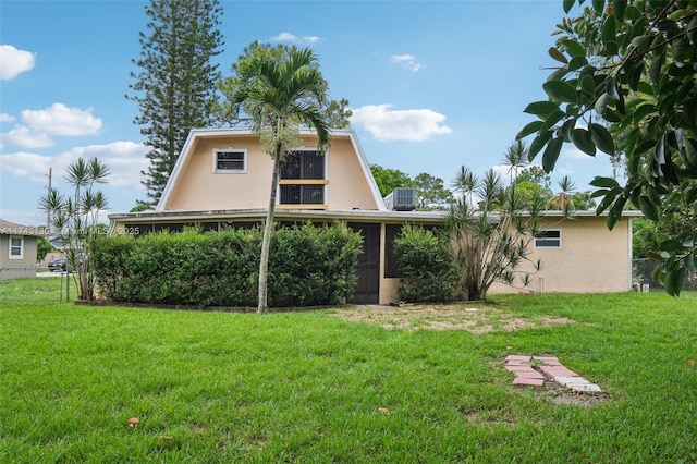 rear view of house featuring a lawn