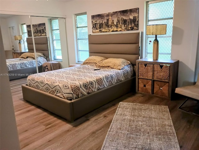 bedroom with a closet and wood finished floors