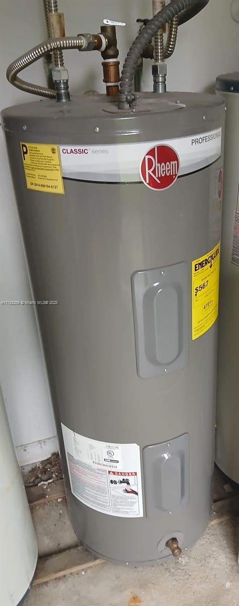 utility room with electric water heater and water heater