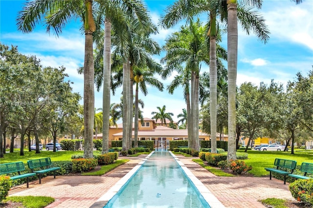 view of pool with a lawn