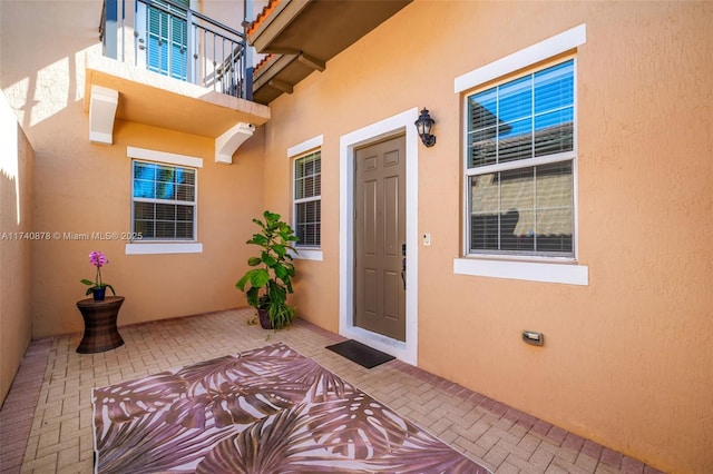 doorway to property with a patio area