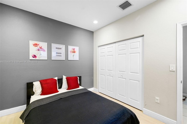 bedroom featuring a closet and light hardwood / wood-style flooring