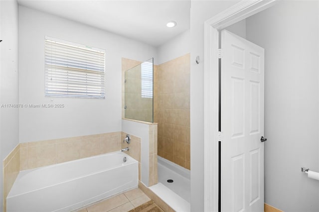 bathroom featuring shower with separate bathtub and tile patterned flooring