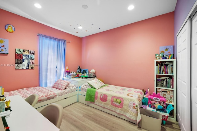 bedroom with hardwood / wood-style floors and a closet