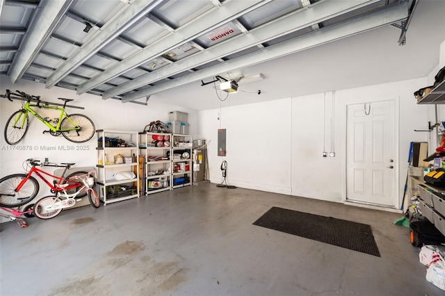 garage with a garage door opener and electric panel