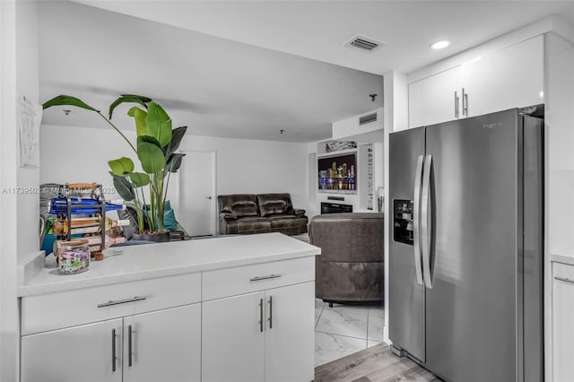 661 NE 195th St Unit 312, Miami, FL 33179 - kitchen featuring white cabinetry and stainless steel fridge