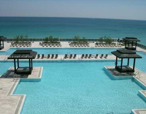 view of swimming pool with a water view