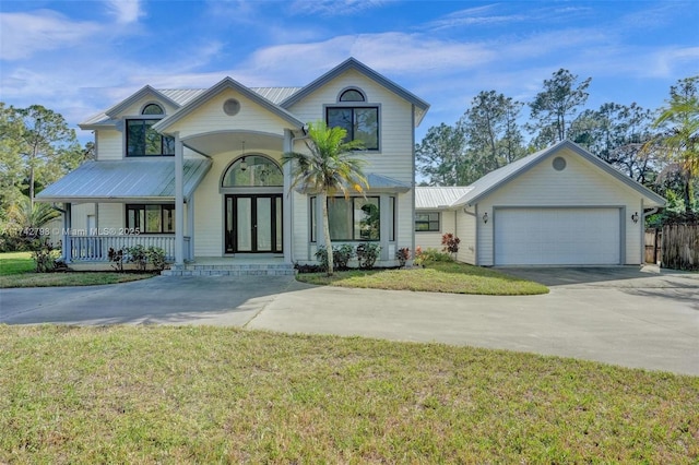 view of front of home featuring a garage, a porch, and a front lawn