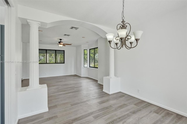 empty room with ceiling fan, light hardwood / wood-style floors, and ornate columns