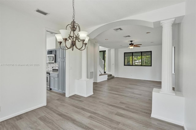 unfurnished dining area featuring ornate columns, ceiling fan, and light hardwood / wood-style floors