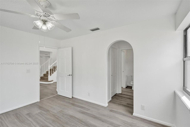 spare room with ceiling fan and light wood-type flooring