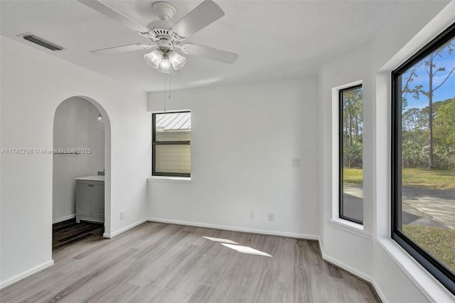 unfurnished room with ceiling fan and light hardwood / wood-style flooring