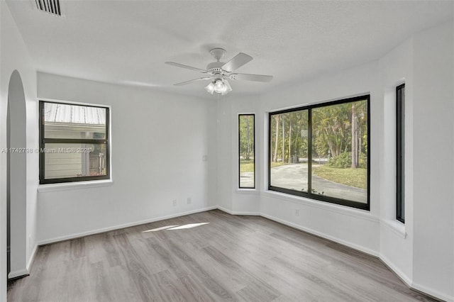 unfurnished room featuring ceiling fan, a textured ceiling, and light hardwood / wood-style flooring