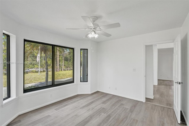 spare room with ceiling fan and light hardwood / wood-style flooring