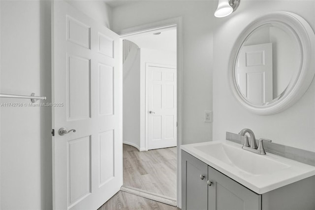 bathroom with hardwood / wood-style flooring and vanity