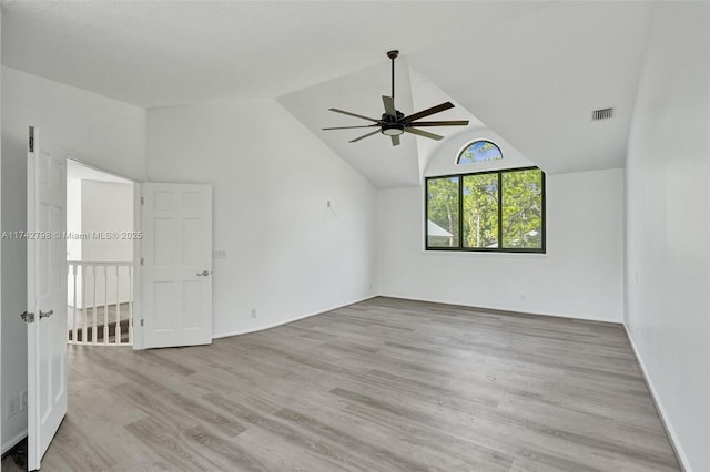 spare room with vaulted ceiling, light hardwood / wood-style floors, and ceiling fan