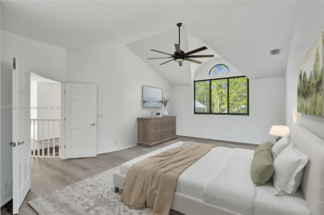 bedroom featuring ceiling fan, lofted ceiling, and light wood-type flooring