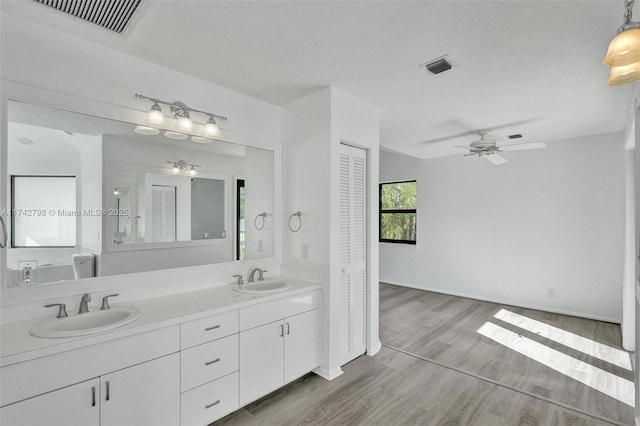 bathroom featuring vanity, hardwood / wood-style floors, and ceiling fan