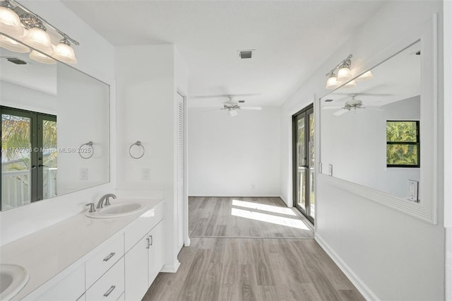 bathroom featuring french doors, ceiling fan, vanity, and hardwood / wood-style floors