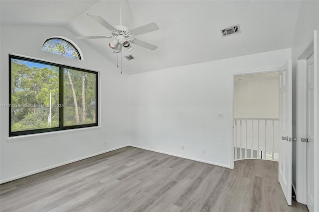 unfurnished room with lofted ceiling, ceiling fan, and light hardwood / wood-style flooring