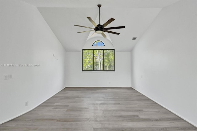 empty room with vaulted ceiling, ceiling fan, and light hardwood / wood-style flooring