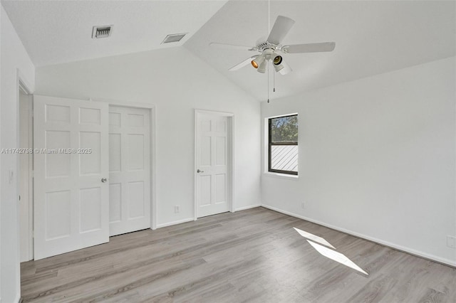 unfurnished bedroom featuring lofted ceiling, light hardwood / wood-style floors, and ceiling fan