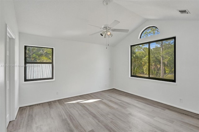 empty room featuring light hardwood / wood-style flooring and vaulted ceiling