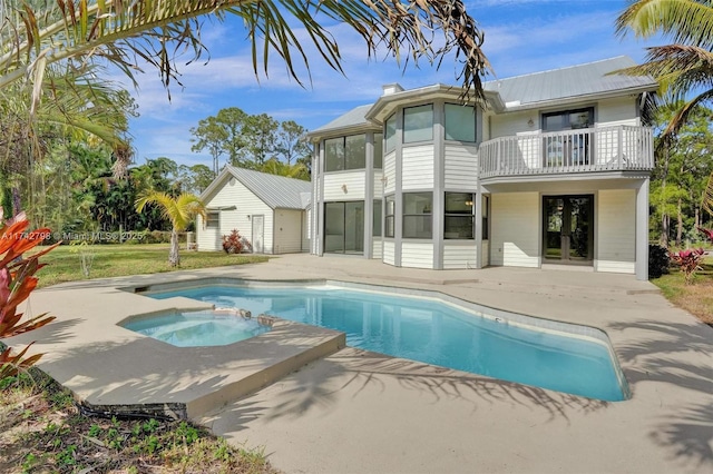 back of property featuring a patio area, a sunroom, french doors, and a balcony