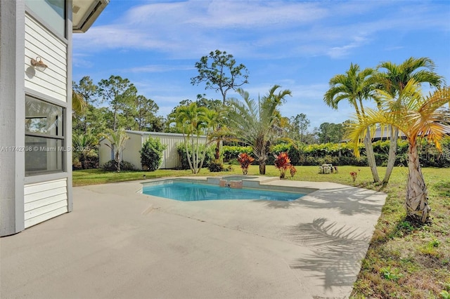 view of pool featuring an in ground hot tub, a patio area, and a lawn