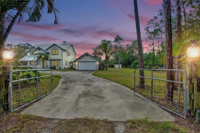 view of front of home with a lawn and an outdoor structure