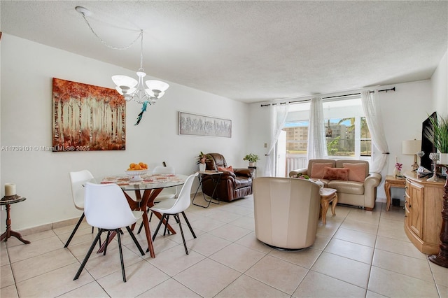 tiled dining area with a textured ceiling and a notable chandelier