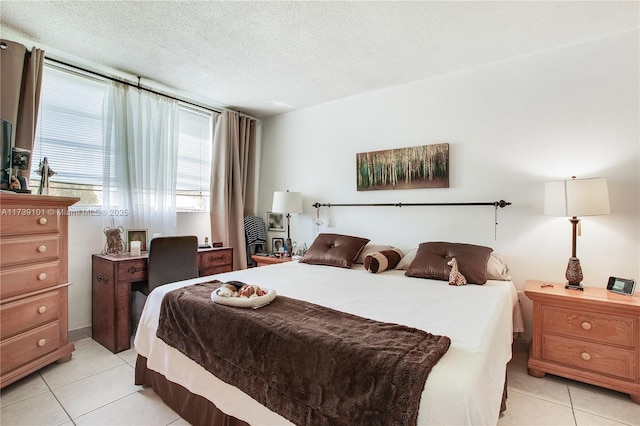 tiled bedroom featuring a textured ceiling