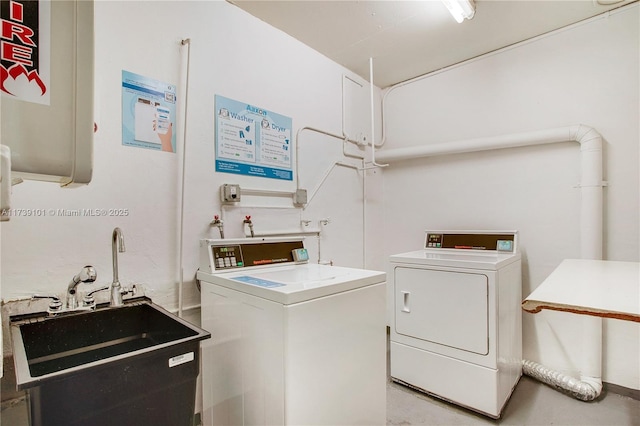 washroom with sink and washing machine and dryer