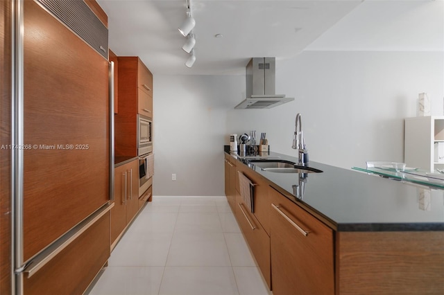 kitchen featuring sink, stainless steel oven, light tile patterned floors, paneled fridge, and exhaust hood