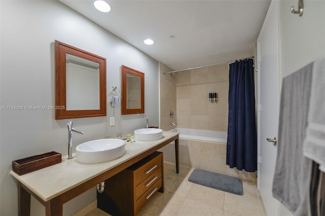 bathroom with shower / tub combo with curtain, vanity, and tile patterned floors