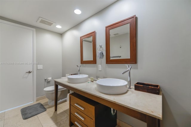 bathroom featuring vanity, tile patterned flooring, and toilet