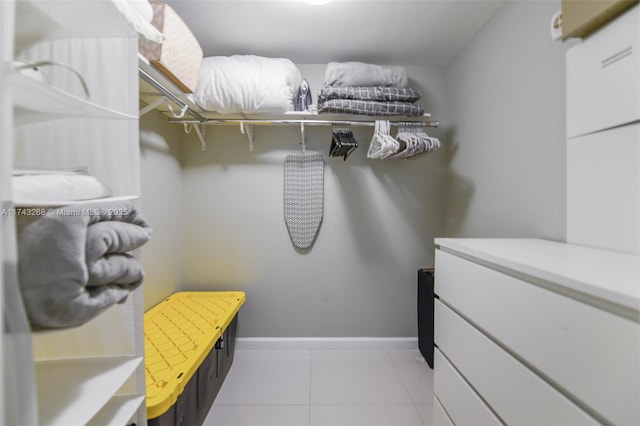 walk in closet with light tile patterned flooring