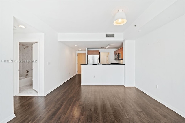 unfurnished living room featuring dark hardwood / wood-style floors